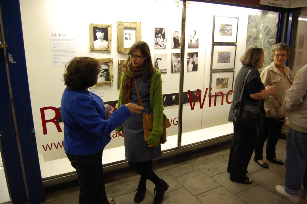 window gallery outside people leaning